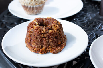 A view of a small banana nut bundt cake on a plate.