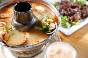 A view of a tom kha seafood soup.