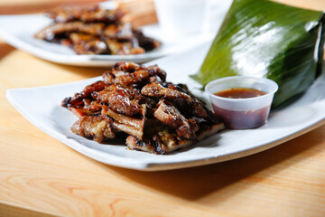 A view of a plate of pork satay.