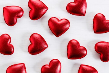Fototapeta premium Red hearts on wooden background. Top view.