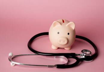 Piggy bank with stethoscope to present finance health and saving plan.