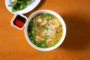 A top down view of a bowl of shrimp pho.
