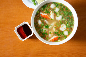 A top down view of a bowl of seafood pho. © DAVID