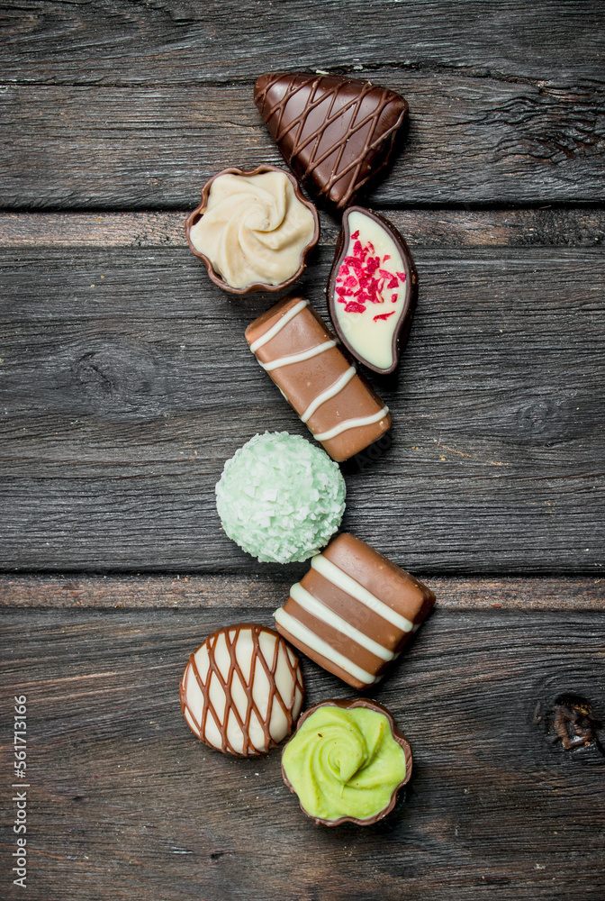 Sticker Chocolate sweets with nuts and various fillings.