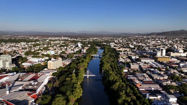 Aerial view over bridges on the R&iacute;o Tamazula river, golden hour in Culiacan, Mexico
