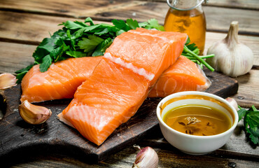 Raw salmon fish filet with spices and fresh parsley.