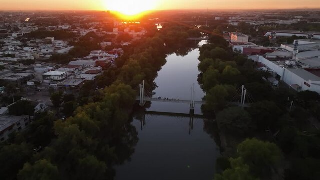 Aerial view over the Bimodal Bridge on R&iacute;o Tamazula, sunset in Culiacan, Mexico