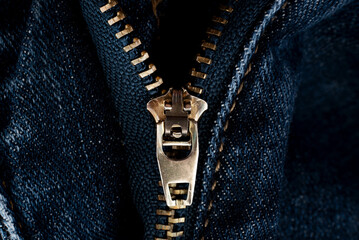 Closeup of zipper in blue jeans. Zipper with lock. A piece of denim