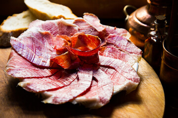Iberico ham cut into slices. Iberian ham is a type of serrano ham from the Iberian pig, highly...