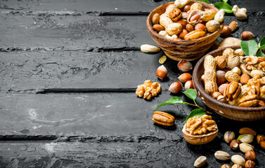 Assortment of different types of nuts in bowls.