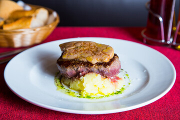 Beef tenderloin with grilled foie on top and sauce. Dish in a luxury restaurant in Spain.