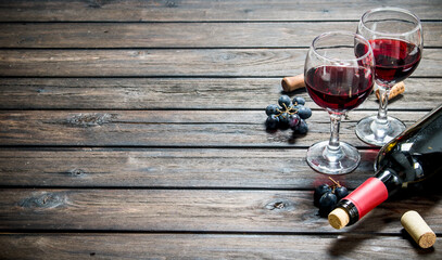 Wine background. Red wine with black grapes.