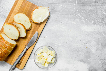 Breakfast. Fresh bread and butter on a wooden Board.