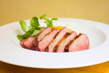 Duck magret cooked in the oven and cut into slices.