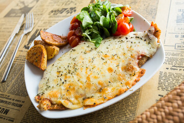 Milanese with Argentinian cheese. The milanesa is a fillet, usually beef, that is cooked fried or baked.