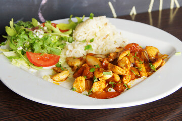 Lunch combi chicken dish with rice and salad.
