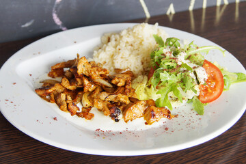 Lunch combi chicken dish with rice and salad.