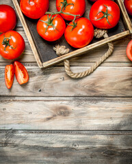 Ripe tomatoes on tray.