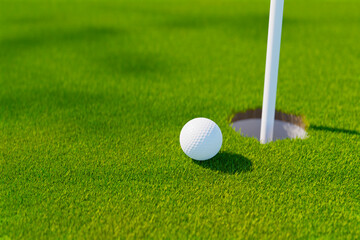 golf ball next golf hole on grass field, 3d rendering