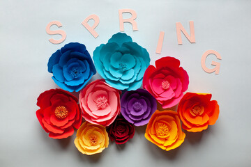 Handmade paper cutout flowers with spring lettering. Backstage. On white background.