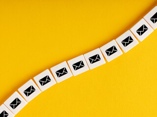 Cubes with chain mail icons on yellow background. Spamming, spam email. Connection and communication technology.