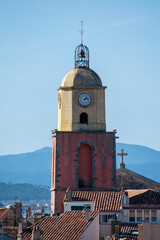 Fototapeta na wymiar Saint Tropez church tower with clock against blue sky