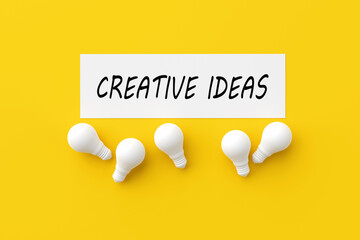 The word creative ideas on white paper with light bulbs. Creative Design Ideas Imagination Innovation