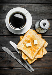 Breakfast. Toasted bread with butter and aromatic coffee.