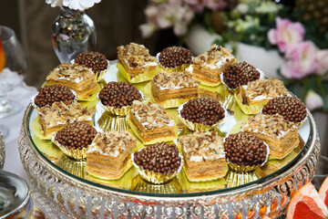Various cakes on a round tray