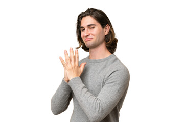Young caucasian man isolated on green chroma background scheming something