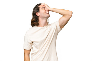 Young caucasian man isolated on green chroma background smiling a lot