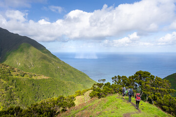 Group of hikers on a hiking trail on São Jorge island in the Azores	