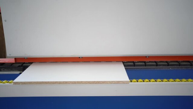 fragment of a machine with an electric motor for the production of furniture and parts from chipboard. Automatic laminating chipboard. the concept of production, fabrication and woodworking industry