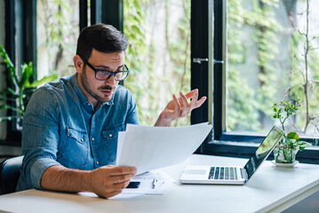 Professional bookkeeper, accountant or businessman, comparing yearly company income.