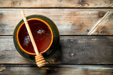Honey in a pot with a spoon.