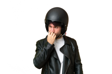 Young caucasian man with a motorcycle helmet isolated on green chroma background having doubts