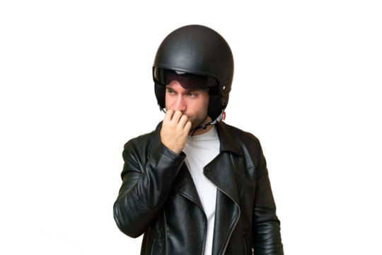 Young caucasian man with a motorcycle helmet isolated on green chroma background having doubts