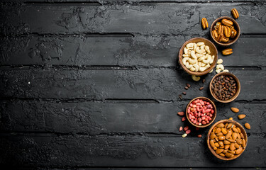 Assortment of different nuts in bowls.