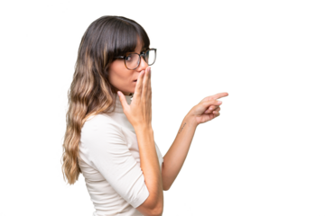 Young caucasian woman over isolated background with surprise expression while pointing side