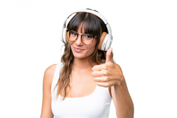 Young caucasian woman over isolated background listening music and with thumb up