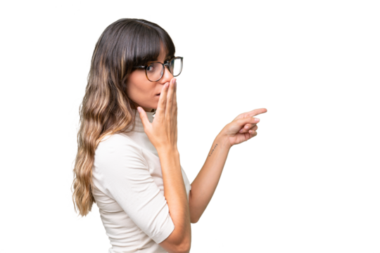 Young caucasian woman over isolated background with surprise expression while pointing side