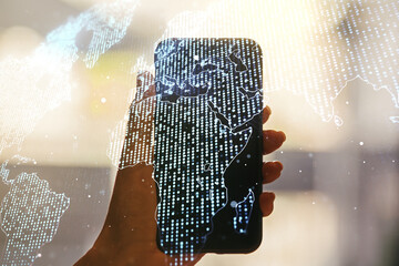 Multi exposure of abstract creative digital world map and hand with cell phone on background, research and analytics concept