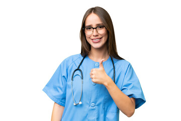 Young nurse caucasian woman over isolated background giving a thumbs up gesture