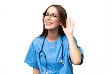 Young nurse caucasian woman over isolated background listening to something by putting hand on the ear
