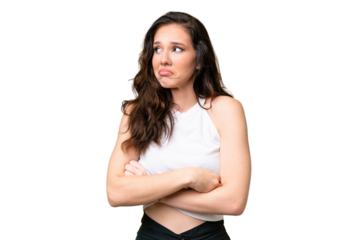 Young caucasian woman isolated over isolated background making doubts gesture while lifting the shoulders