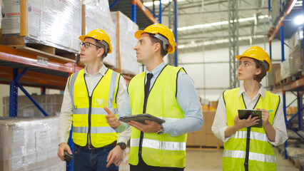 Teamwork of workers working in large warehouse retail store industry.Rack of stock storage. Interior of cargo in ecommerce and logistic concept. Depot. People lifestyle. Shipment service for container