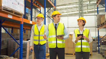 Teamwork of workers working in large warehouse retail store industry.Rack of stock storage. Interior of cargo in ecommerce and logistic concept. Depot. People lifestyle. Shipment service for container