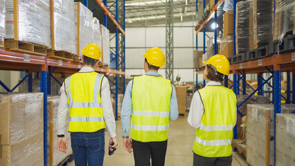 Teamwork of workers working in large warehouse retail store industry.Rack of stock storage. Interior of cargo in ecommerce and logistic concept. Depot. People lifestyle. Shipment service for container