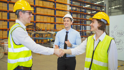 Teamwork of workers working in large warehouse retail store industry.Rack of stock storage. Interior of cargo in ecommerce and logistic concept. Depot. People lifestyle. Shipment service for container