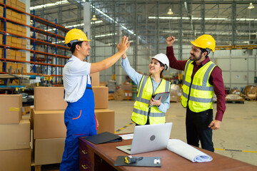 Teamwork group of Asian man worker working in large warehouse retail store industry factory. Rack of stock storage. Cargo in ecommerce and logistic concept. Depot. People lifestyle. Shipment service.